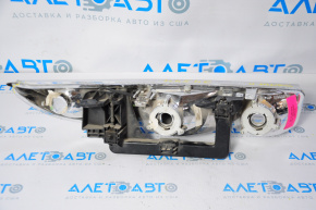 Left front headlight for a Saturn S-series coupe (97-00), halogen, missing chrome, scratches