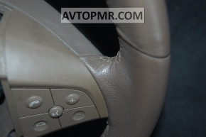 The bare steering wheel of a Mercedes X164 GL pre-restoration is brown.