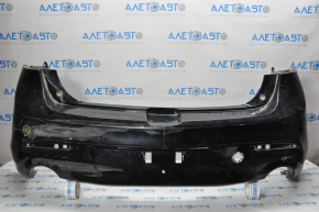 The rear bumper is bare and needs repair for a Mazda3 MPS 2009-2013. It's black and has a hole in it and a dent.