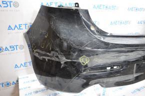 The rear bumper is bare and needs repair for a Mazda3 MPS 2009-2013. It's black and has a hole in it and a dent.