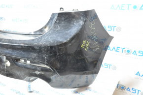 The rear bumper is bare and needs repair for a Mazda3 MPS 2009-2013. It's black and has a hole in it and a dent.