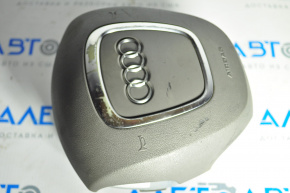 The steering wheel airbag for the driver's side of the Audi A4 B8 08-12 pre-restoration model has worn chrome and scratches.