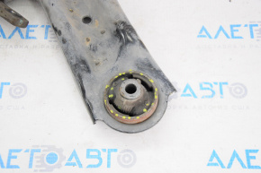 The lower front right control arm of a 14-20 Nissan Rogue has a torn silent block.