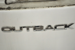 The Outback emblem on the Subaru Outback 10-14 trunk door.