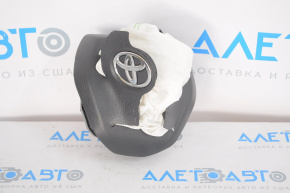 The airbag in the driver's steering wheel of a Toyota Camry v70 18-24 is black and has been shot.