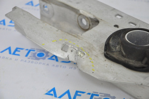 The lower control arm under the rear right spring of the Ford Escape MK4 20-26 is dented.
