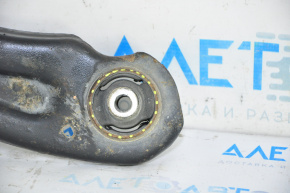 The lower front right control arm of a VW Jetta 11-18 USA has a torn silent block.