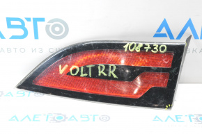 The right inner taillight of a Chevrolet Volt 11-15 has a broken mount and a chip.