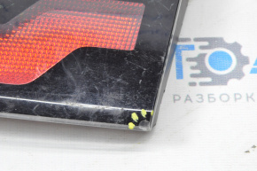 The right inner taillight of a Chevrolet Volt 11-15 has a broken mount and a chip.