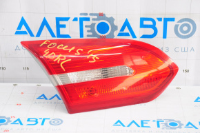 The left inner taillight on a Ford Focus mk3 15-18 restyling 4D has swollen paint.