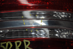 The right headlight of a Mercedes X164 GL has become cloudy and needs polishing.