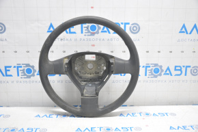 The steering wheel is bare, plastic, black, and a VW Tiguan 09-11 pre-restoration model.