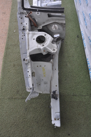 The front right quarter of a Toyota Avalon 05-10 is white and dented.