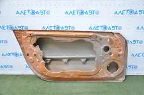 The front left door of a Nissan 350z orange A53 is bare and dented at the bottom.
