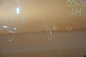 The front left door of a Nissan 350z orange A53 is bare and dented at the bottom.