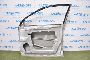 The front right door of a Nissan Murano z50 03-07 is bare and silver. It has a dent and bumps.