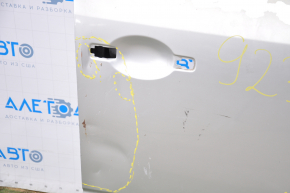 The front right door of a Nissan Murano z50 03-07 is bare and silver. It has a dent and bumps.