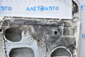 The door is bare, front left, Toyota Sienna 04-09, white, dented corner, bumps, burnt