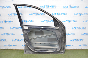 The front left door of a Mercedes X164 GL W164 ML is bare and has blue dents and bumps.
