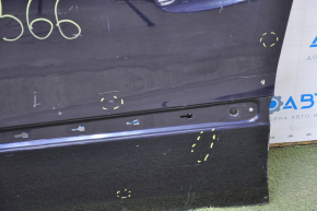 The front left door of a Mercedes X164 GL W164 ML is bare and has blue dents and bumps.