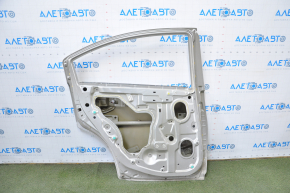 The door is bare, rear left, Mitsubishi Galant 04-06 pre-rest silver, dented, bumps