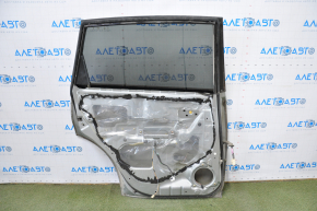 Subaru b9 Tribeca rear left door assembly, silver, dent in the lower corner, bumps, painted
