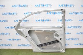 The rear left door of a Mercedes W221 long silver is bare, the bottom is dented, and the bumps are missing.