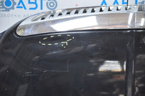 The hood assembly of a 98-11 Lincoln Town Car has black bumps, bulging chrome, and a broken grille.