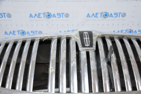 The hood assembly of a 98-11 Lincoln Town Car has black bumps, bulging chrome, and a broken grille.