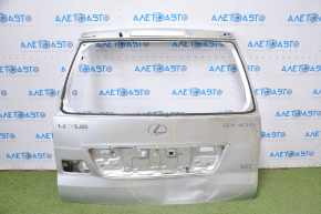 The trunk door of a Lexus GX470 03-09 is dented.