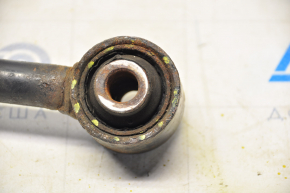 The rear right control arm of a Jeep Compass 11-16 has a torn silent block.