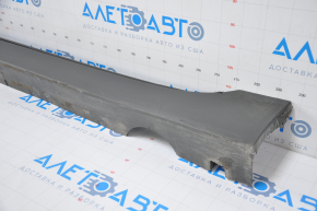 The left threshold of the Chevrolet Volt 11-15 with a seal is dented, the fasteners are broken, there are tears, and it is filed down.