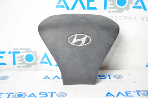The steering wheel airbag on the driver's side of the Hyundai Sonata 11-15 has a dent on the badge.