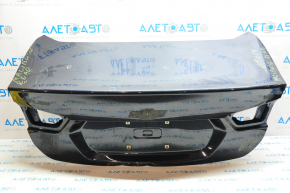 The trunk lid of Chevrolet Malibu 16-23 is dented at the bottom edge, pokes