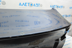 The trunk lid of Chevrolet Malibu 16-23 is dented at the bottom edge, pokes