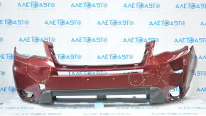 The front bumper of a Subaru Forester 14-16 SJ pre-rest red is dented, has tears, broken fasteners, and scratches.