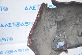 The front bumper of a Subaru Forester 14-16 SJ pre-rest red is dented, has tears, broken fasteners, and scratches.