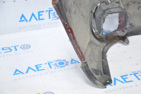 The front bumper of a Subaru Forester 14-16 SJ pre-rest red is dented, has tears, broken fasteners, and scratches.