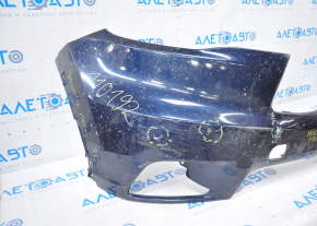The front bumper of a Toyota Highlander 14-16 is bare and blue, dented, has tears, and is missing fragments.