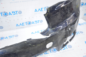 The front bumper of a Toyota Highlander 14-16 is bare and blue, dented, has tears, and is missing fragments.