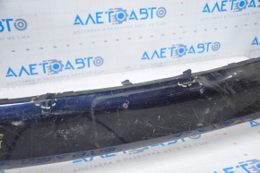 The front bumper of a Toyota Highlander 14-16 is bare and blue, dented, has tears, and is missing fragments.