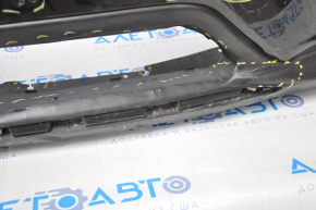 Bare front bumper for a 14-16 Nissan Rogue without a license plate, black, dented, with tears, broken fasteners, filed down, and scratches.