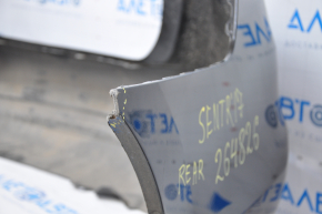Bare rear bumper Nissan Sentra 16-19 rest black tear at the bottom, torn fasteners, sawed corner, dented