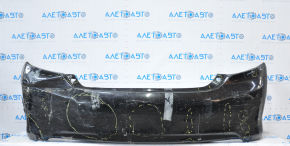 The rear bumper is bare, Toyota Camry v50 12-14 USA LE XLE black, dented, with tears and broken fasteners.