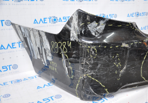 The rear bumper is bare, Toyota Camry v50 12-14 USA LE XLE black, dented, with tears and broken fasteners.