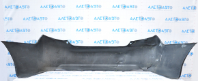 The rear bumper is bare, Toyota Camry v50 12-14 USA LE XLE black, dented, with tears and broken fasteners.