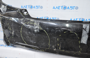 The rear bumper is bare, Toyota Camry v50 12-14 USA LE XLE black, dented, with tears and broken fasteners.
