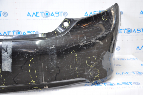 The rear bumper is bare, Toyota Camry v50 12-14 USA LE XLE black, dented, with tears and broken fasteners.