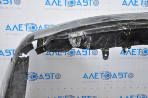 The rear bumper is bare, Toyota Camry v50 12-14 USA LE XLE black, dented, with tears and broken fasteners.
