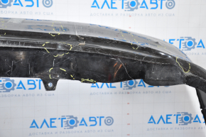 The rear bumper is bare, Toyota Camry v50 12-14 USA LE XLE black, dented, with tears and broken fasteners.